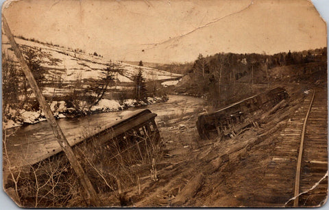 Train postcard - 2 cars wrecked, off the railroad tracks, one on its side RPPC -